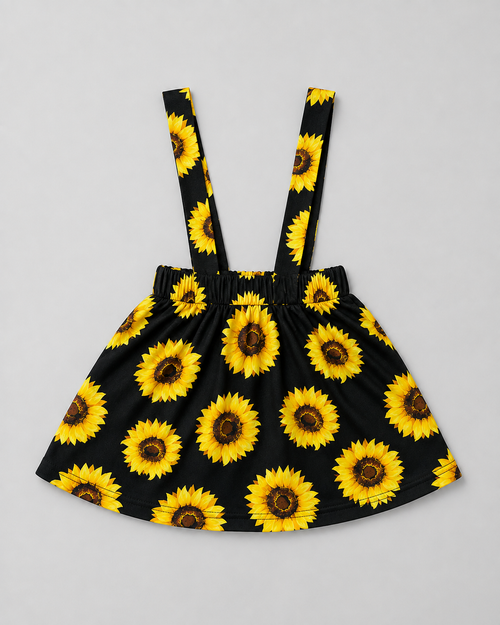 Shop this adorable black and sunflower girls dress featuring a vibrant sunflower print, gathered skirt, elasticized waist, and suspender-style shoulder straps. Perfect for everyday wear, summer outings, photos, and special occasions.