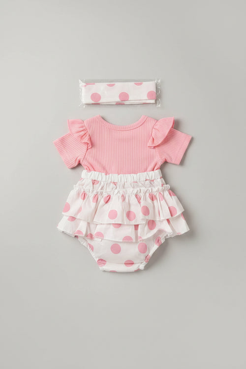 Baby girl pink polka dot bubble romper featuring an embroidered teddy bear applique, flutter sleeves, layered ruffles, and a matching headband. A boutique outfit perfect for birthdays, family photos, baby showers, and everyday wear.
