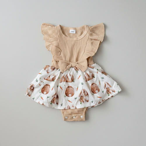 Adorable Baby Girls Bunny Print Dress Romper featuring flutter sleeves, a soft ribbed bodice, bunny print skirt, and built-in romper. Perfect for Easter, spring, birthdays, and everyday boutique style.