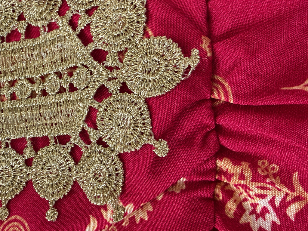 Closeup of Elegant girls' burgundy cold shoulder dress with gold embroidery and foil details. Perfect for holidays, birthdays, weddings, and special occasions.