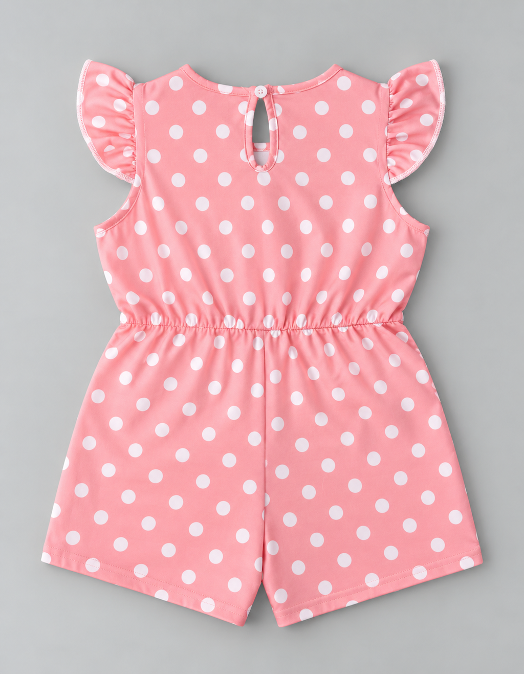 Back view of girls pink and white polka dot romper with ruffle sleeves and keyhole button closure