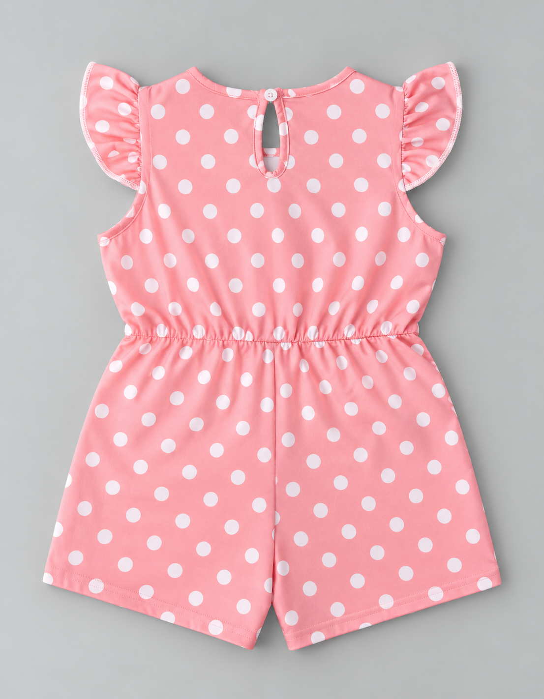 Back view of girls pink and white polka dot romper with ruffle sleeves and keyhole button closure