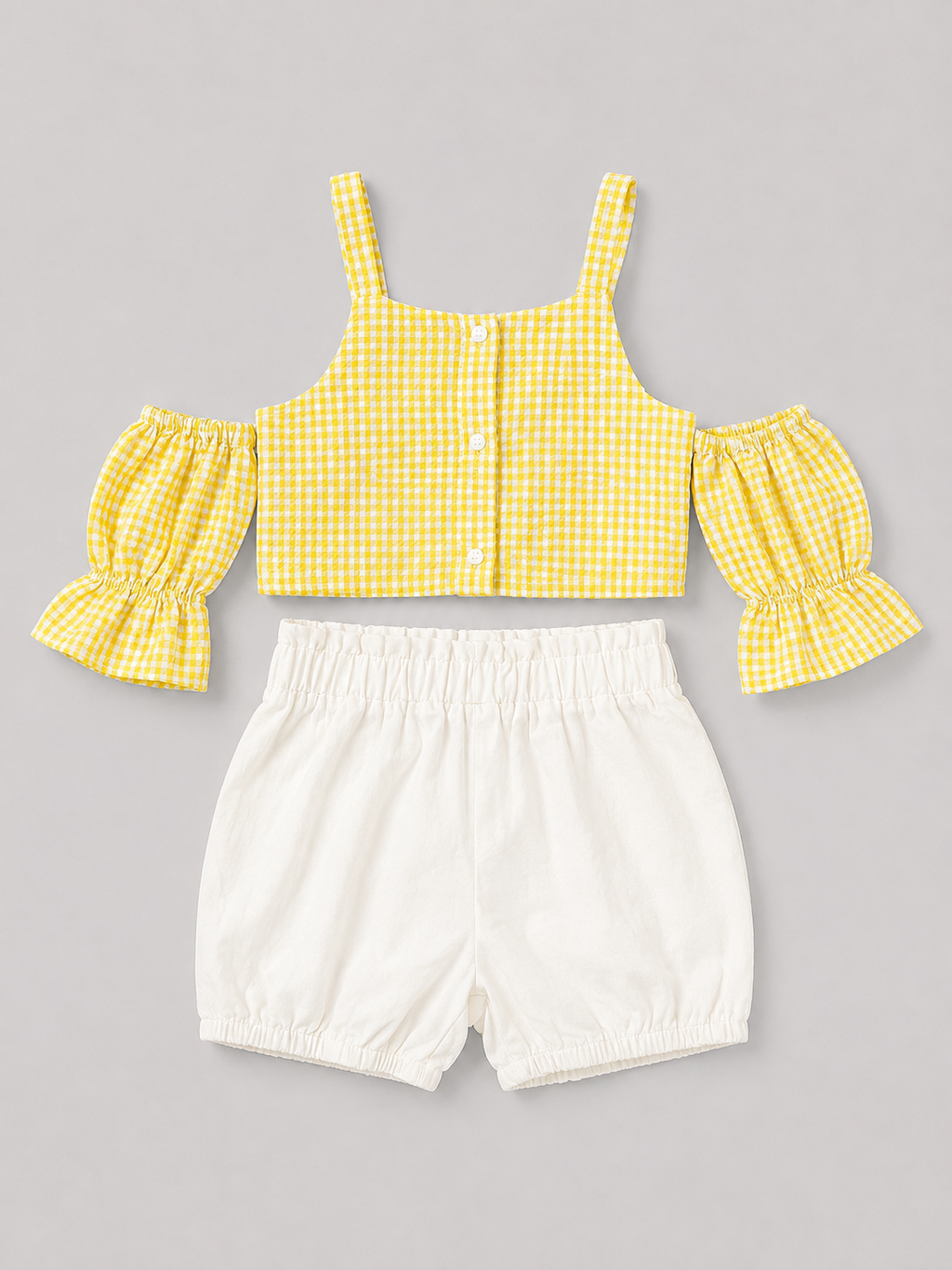 Yellow gingham girls' two-piece outfit featuring a puff-sleeve button-front top and coordinating white bloomer shorts. A sweet summer set for everyday wear, vacations, and special occasions.