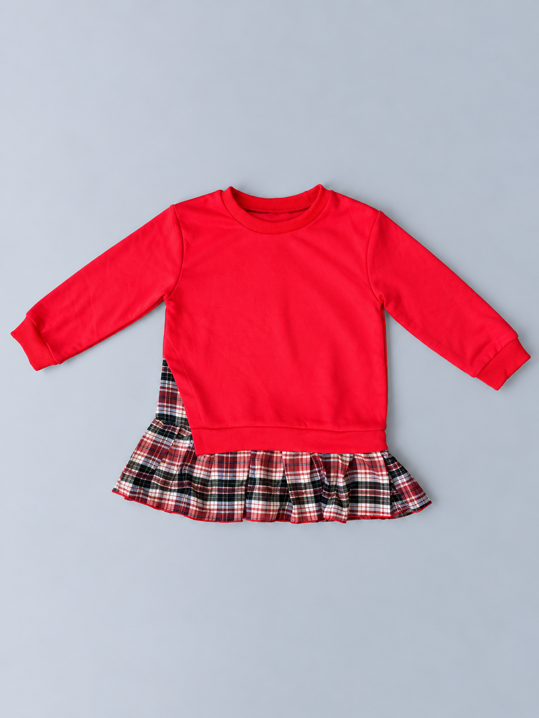 Girls red long-sleeve sweatshirt-style top with red black and white plaid ruffle hem