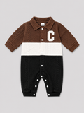 Shop this stylish brown, cream, and black cable knit baby romper featuring a textured design, collared neckline, button front, and convenient snap closures. Perfect for baby boys or girls.