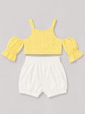 Yellow gingham girls' two-piece outfit featuring a puff-sleeve button-front top and coordinating white bloomer shorts. A sweet summer set for everyday wear, vacations, and special occasions.