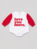 Unisex baby white and red long-sleeve bubble romper with “love you more.” graphic and snap bottom closure, front view, size 9–12M.