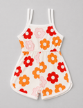 A sleeveless baby romper with a white base and a colorful retro floral pattern featuring red, orange, and pink flowers, laid flat on a neutral gray background.