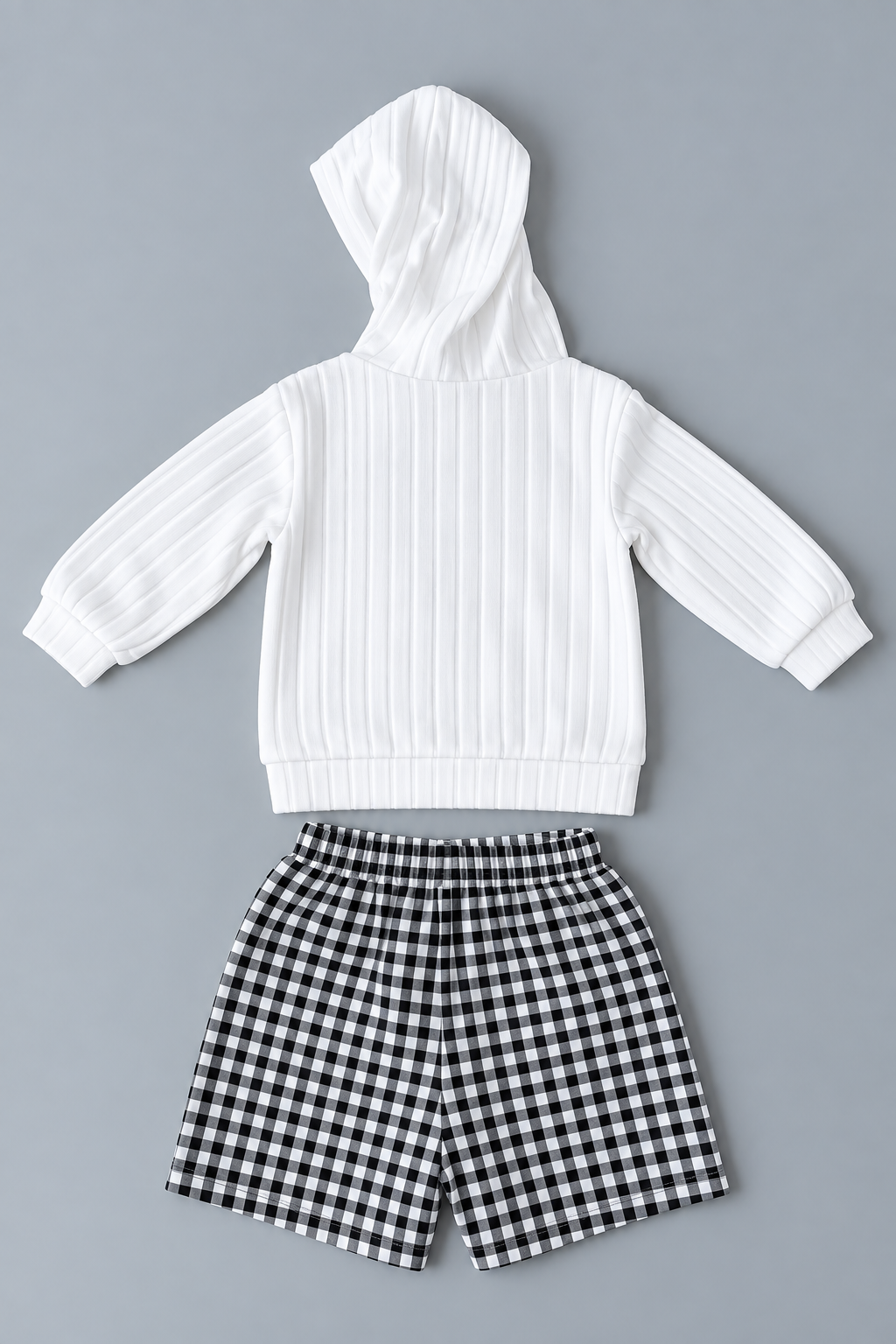 Back view of girls white hooded long-sleeve top with black and white gingham shorts