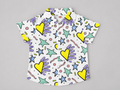 Shop this colorful Hearts & Stars Pattern Boys’ Short Sleeve Shirt featuring bright hearts, stars, and playful geometric details on a white button-up collared shirt. 100% Cotton.