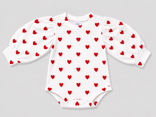 Adorable baby girls' white ribbed bodysuit featuring a red heart print, long puff sleeves, and snap closures. Soft, comfortable, and perfect for Valentine's Day or everyday wear.