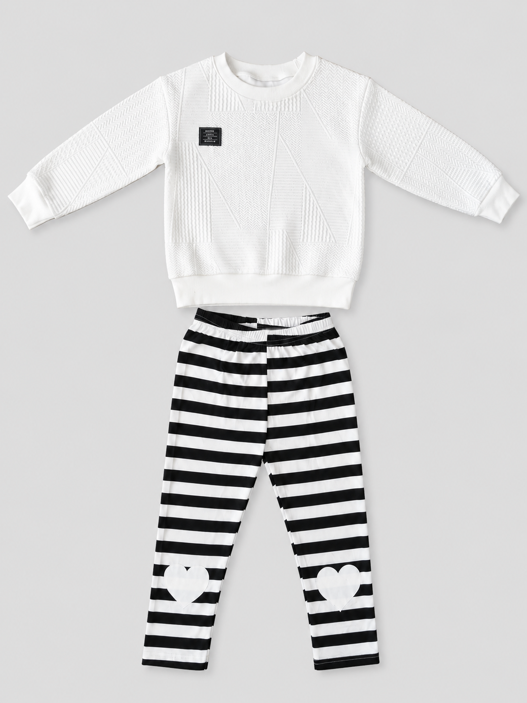Girls white textured sweatshirt and black-and-white striped heart pants two-piece set, front view, size 4–5Y.