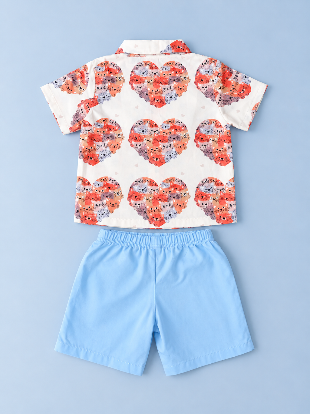 Back view of boys cat heart print collared shirt and solid light blue shorts set