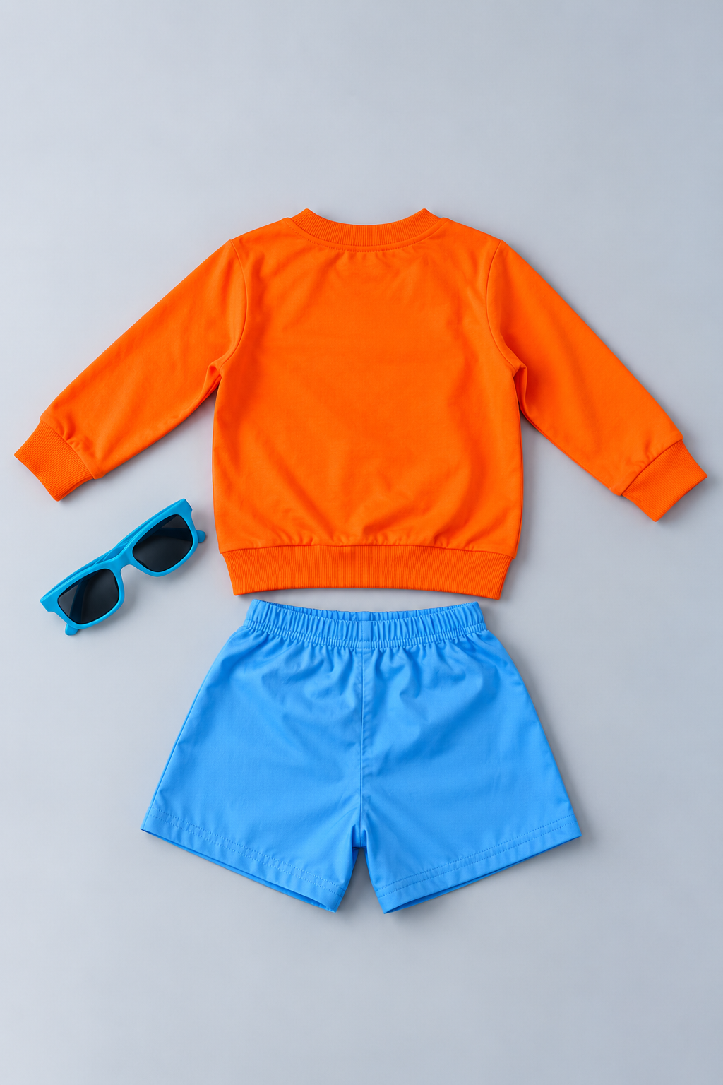 Adorable boys 2-piece outfit featuring a bright orange sweatshirt, blue sunglasses,  and blue shorts with a cool duck graphic. Comfortable boutique clothing perfect for everyday wear, school, playdates, and family outings.