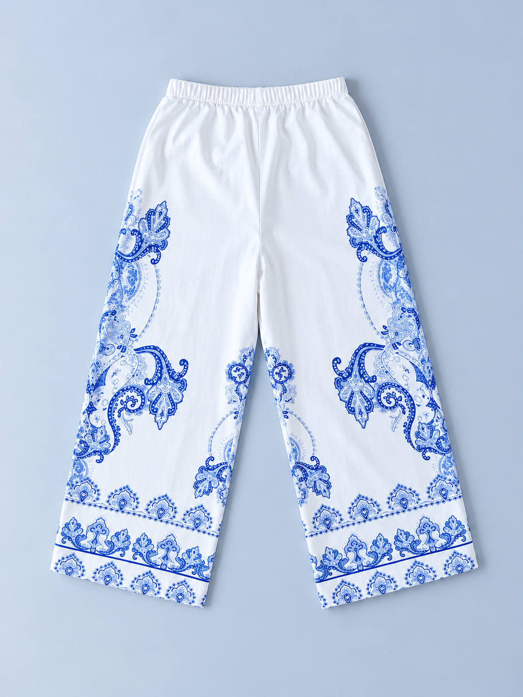 Back view of girls white wide-leg pants with blue paisley-inspired print and elastic waistband