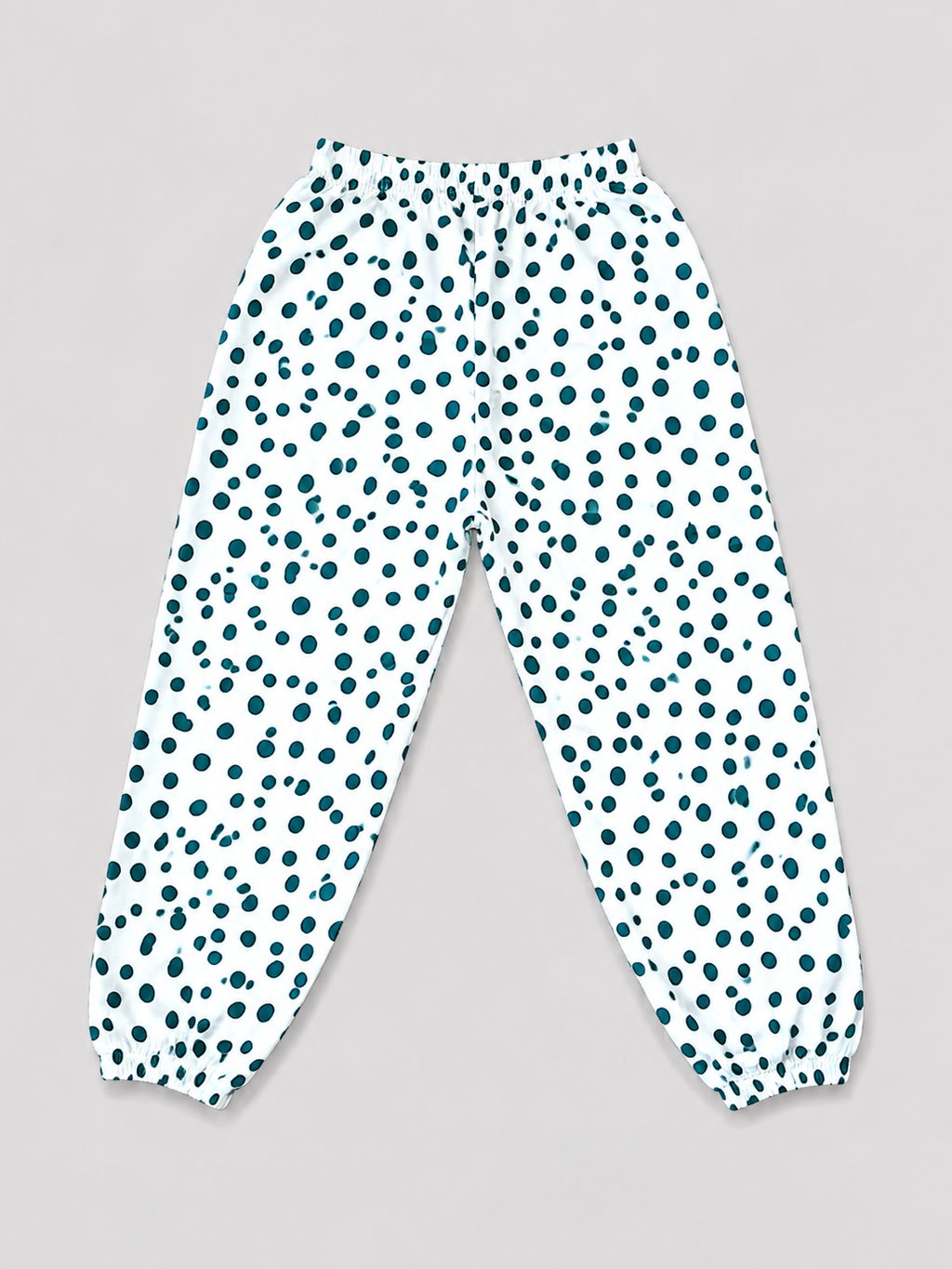Girls white and teal polka dot jogger pants with elastic waistband and gathered ankle cuffs, back view, size 8–10Y.