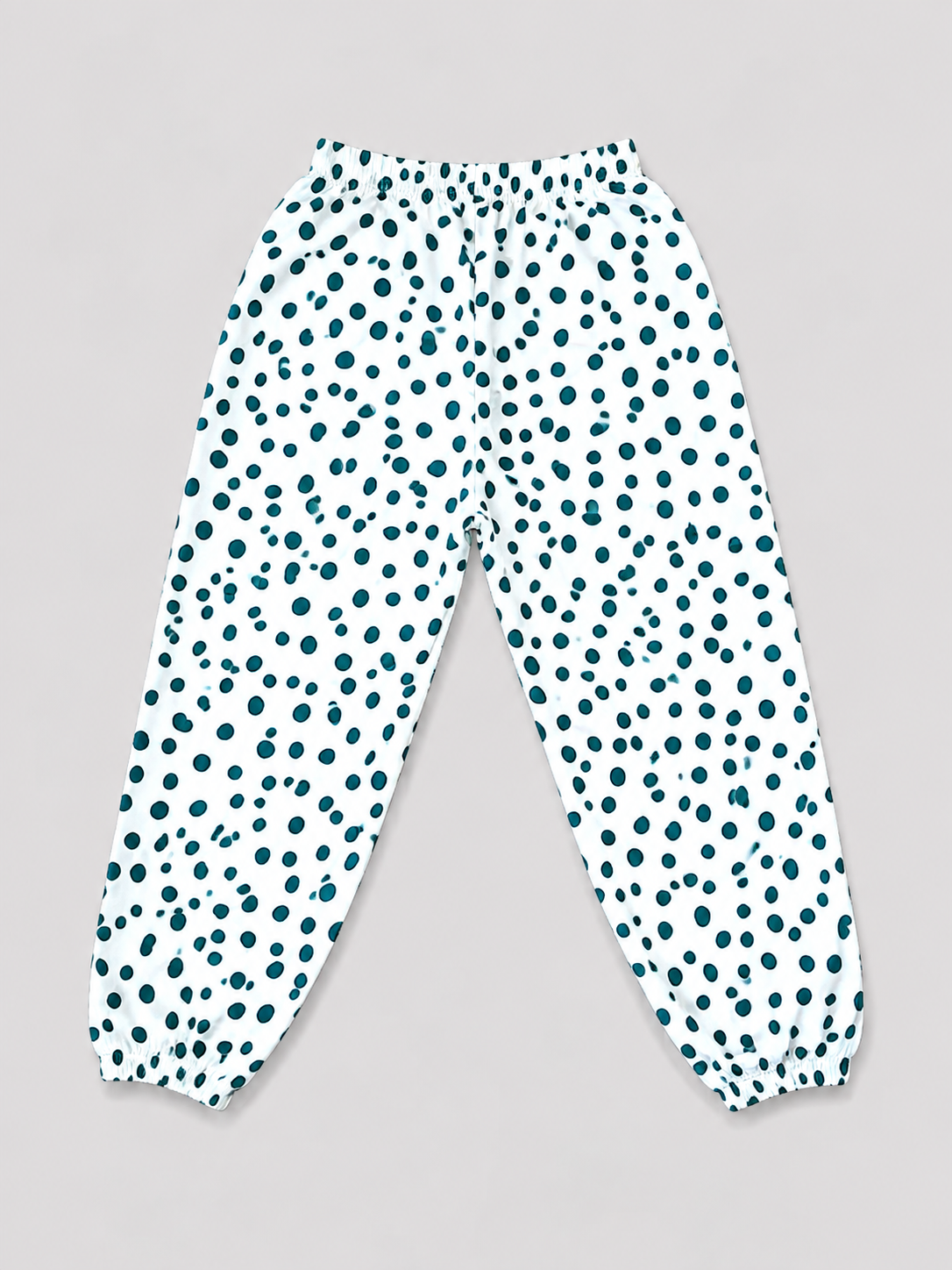 Girls white and teal polka dot jogger pants with elastic waistband and gathered ankle cuffs, back view, size 8–10Y.