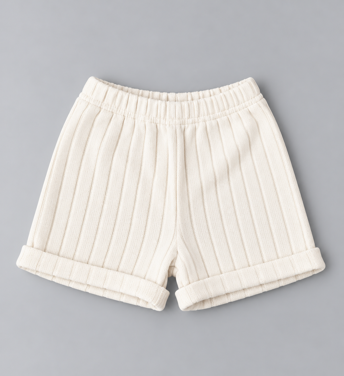 Kids cream ribbed knit pull-on shorts with elastic waistband and rolled cuffs