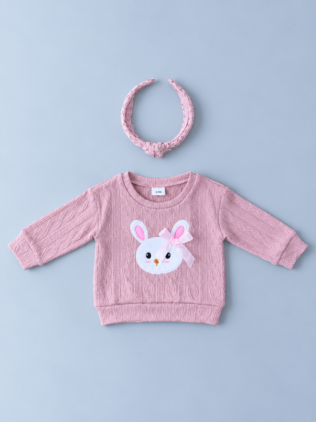 Baby girls pink textured bunny sweatshirt with white bunny appliqué, pink bow, and coordinating floral knotted headband