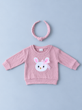 Baby girls pink textured bunny sweatshirt with white bunny appliqué, pink bow, and coordinating floral knotted headband