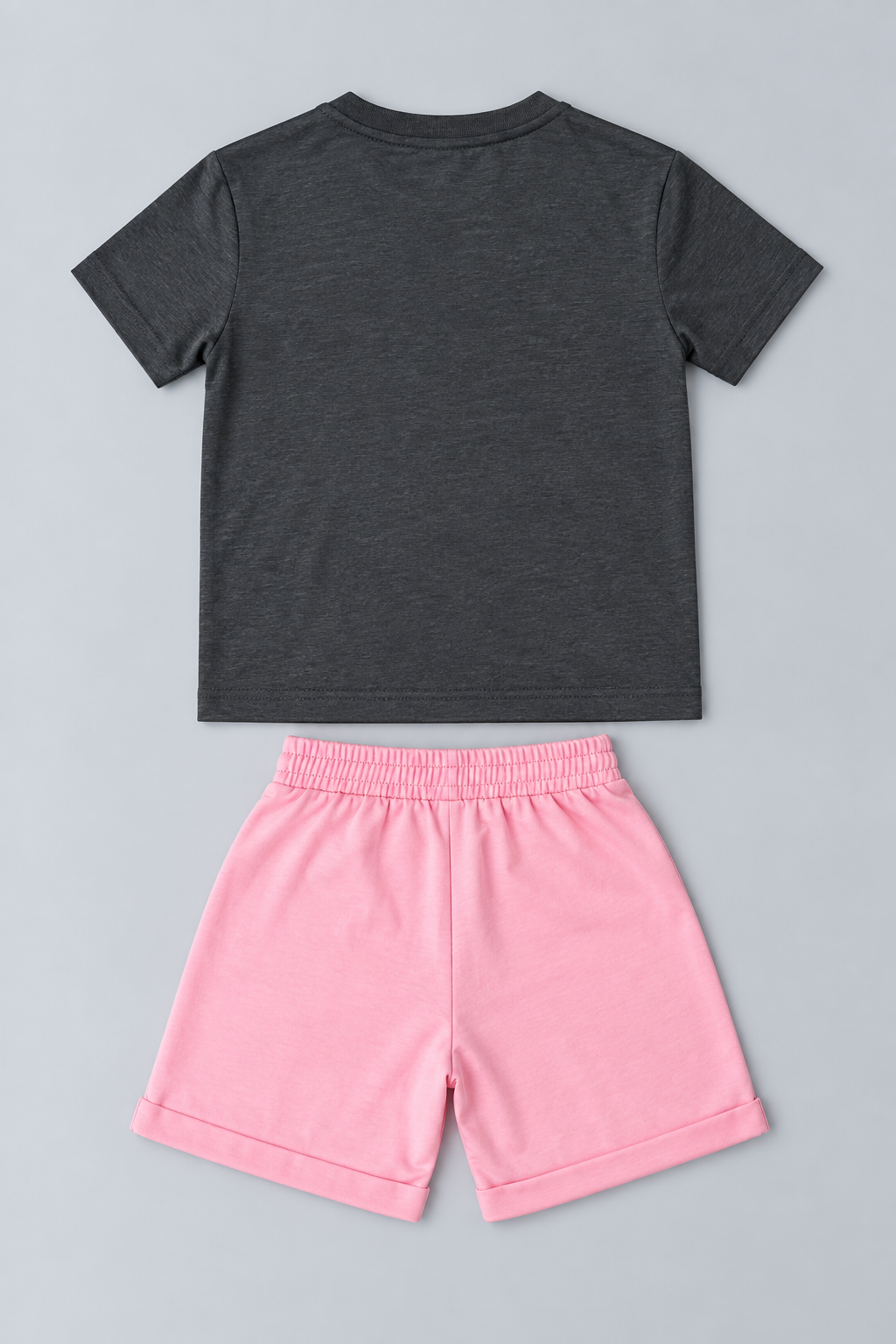 Back view of kids unisex charcoal gray short-sleeve T-shirt and bright pink elastic waist shorts set