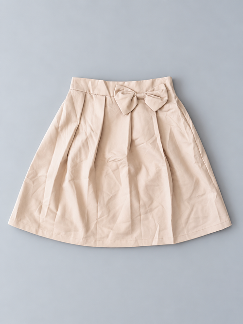 Girls beige pleated skirt with decorative bow and flared silhouette