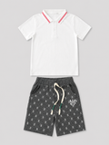 Boys white short-sleeve polo shirt with red striped collar and charcoal gray printed drawstring shorts two-piece set, front view, size 6Y.
