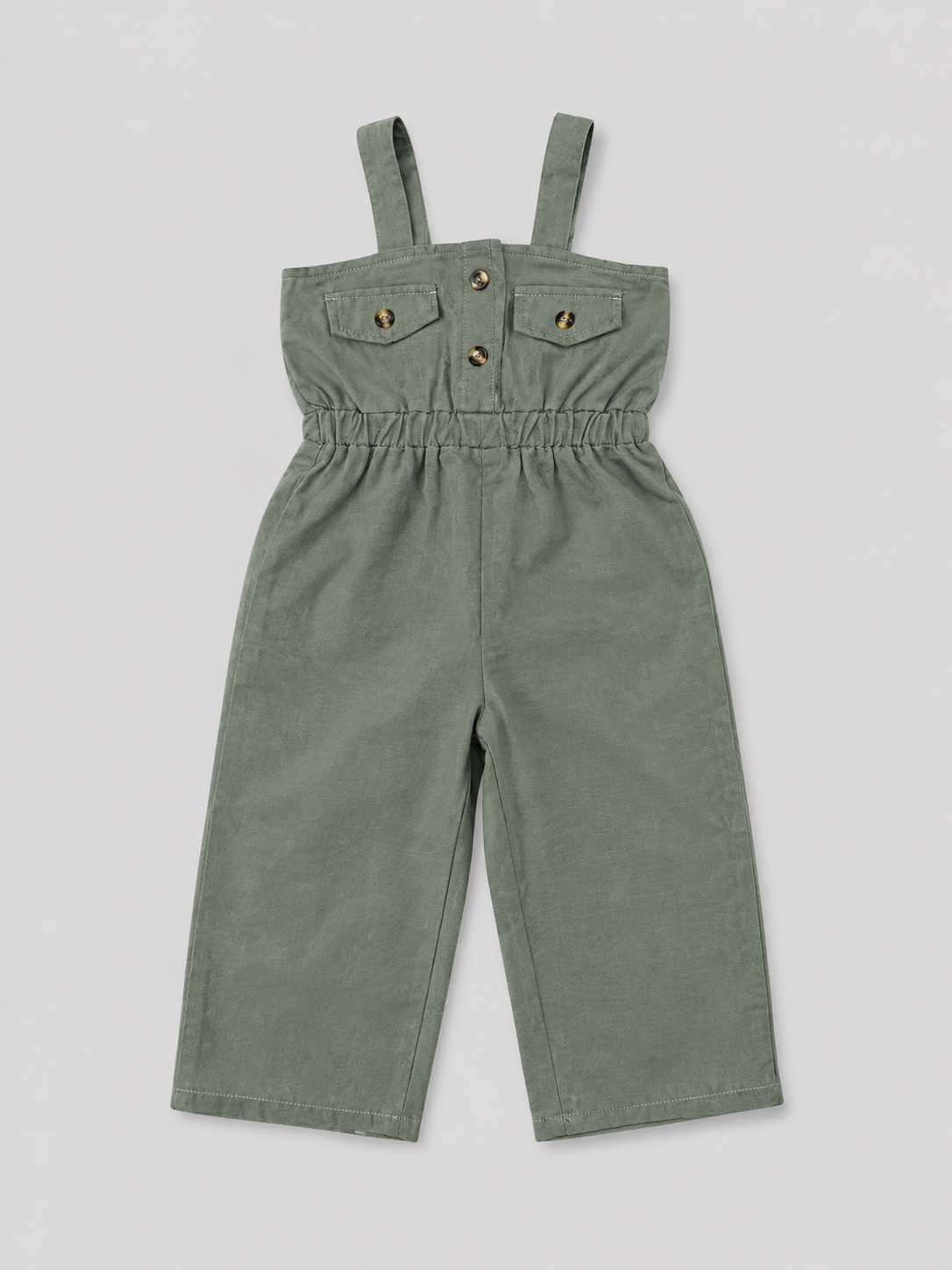 Olive green utility-style jumpsuit for girls featuring a comfortable elasticized waist, wide-leg pants, shoulder straps, and button-flap pocket details. Perfect for casual everyday wear, vacations, and summer outfits.